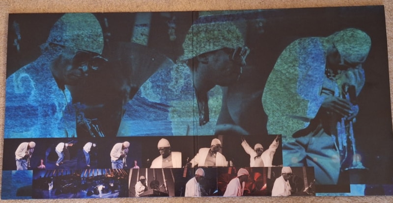 The inside of the gatefold sleeve has various photographs of Miles in concert.