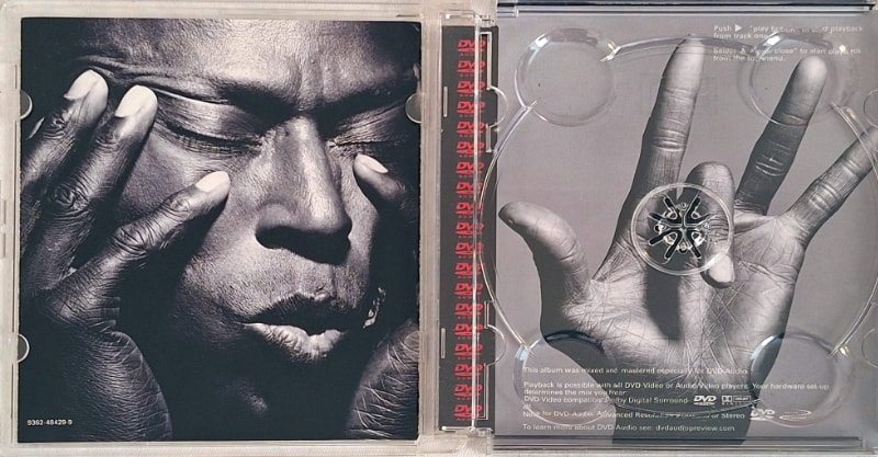 The DVD-A case has a nice inlay image of Miles’s hand from the Tutu back cover.