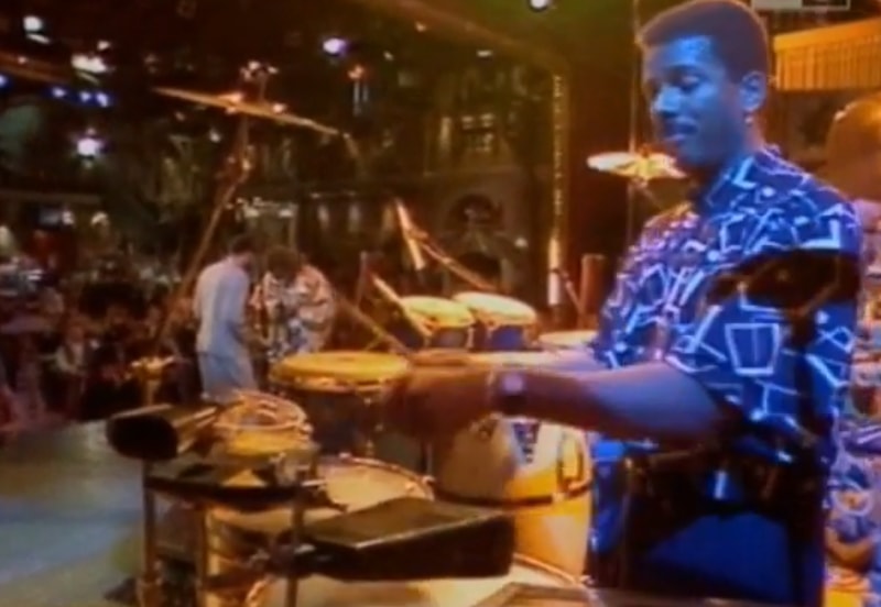 Percussionist Munyungo Jackson plays on stage with Miles Davis in 1989.