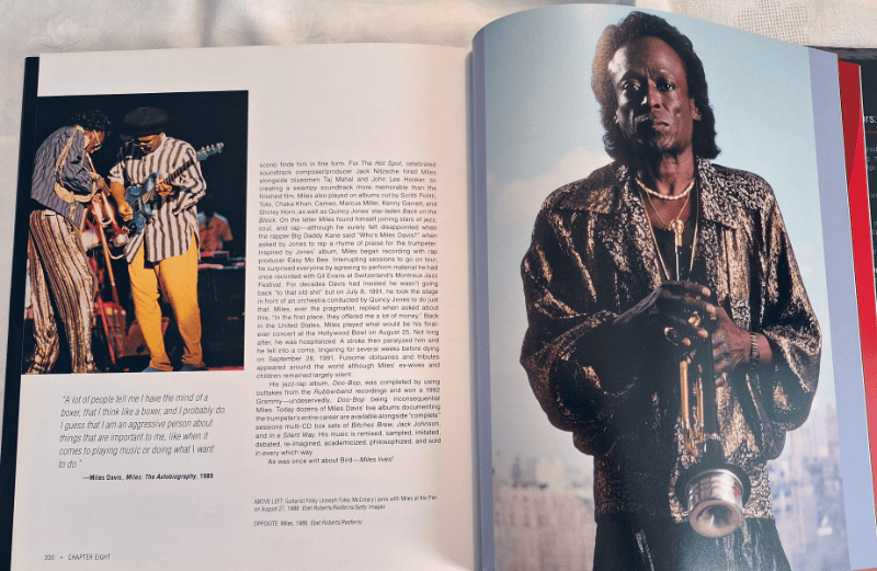 Miles Davis – The Complete Illustrated History spread with portrait of Miles with his trumpet.