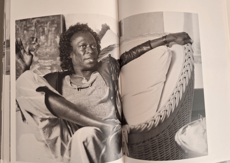 Double spread of Miles Davis sitting and talking.